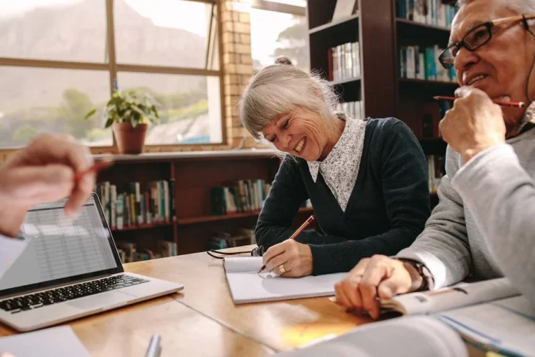 Happy couple signing their reverse mortgage loan