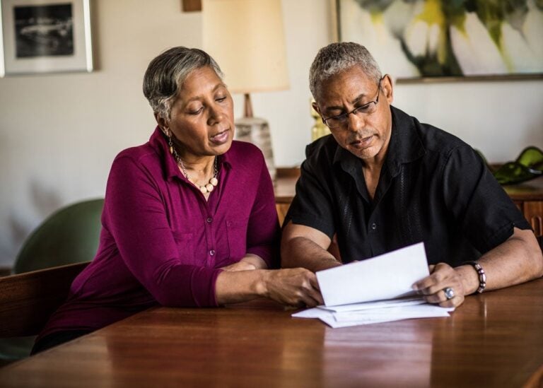 A couple reading how a reverse mortgage works